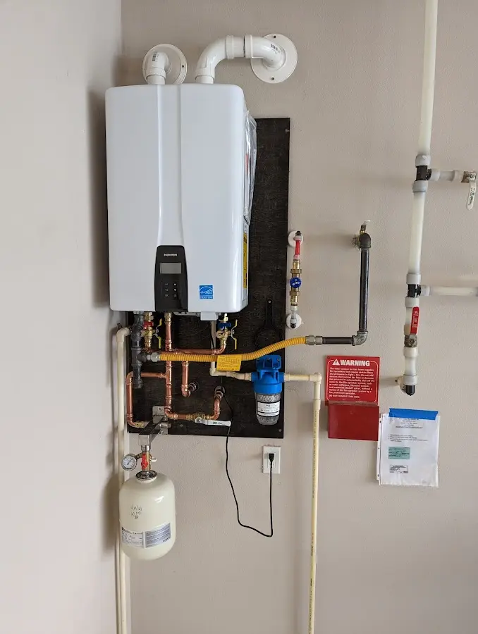 Professional plumber installing copper piping in a North Braddock home